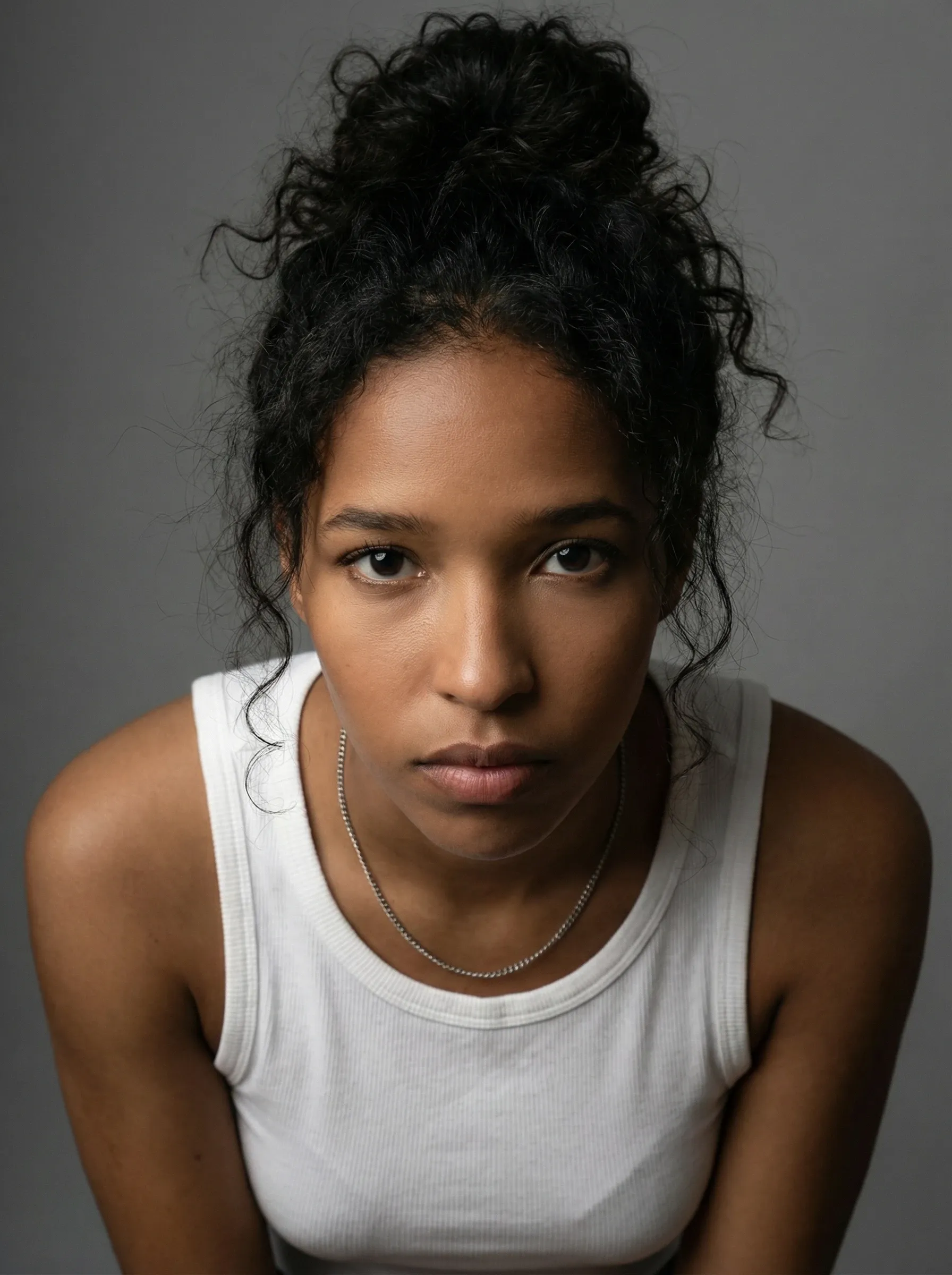 AI actress headshot — woman in a white tank top against a gray studio backdrop